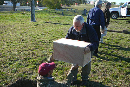 Michael Rhodes and a Troy resident re-inter burial remains